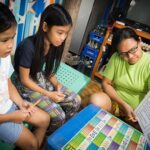 A mother volunteers to help young children who cannot read